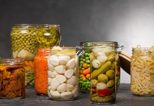 front-view-assortment-vegetables-pickled-clear-glass-jars-2048x1152
